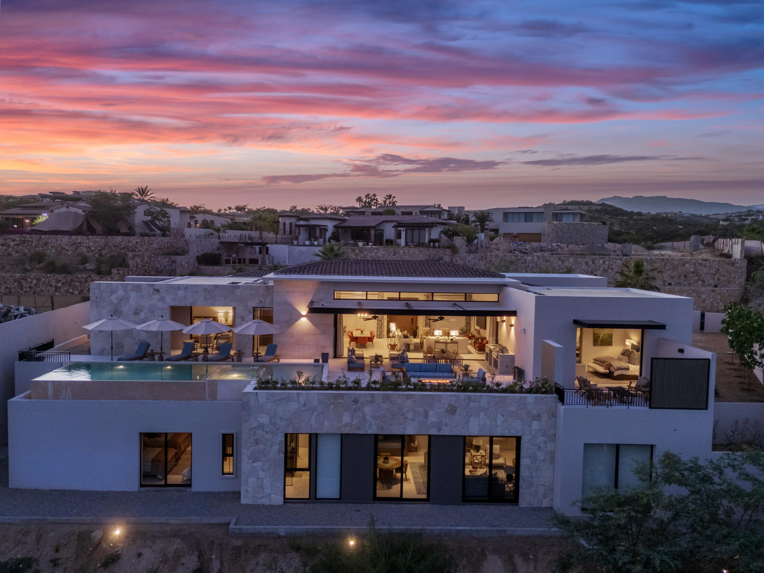 Los Cabos Luxury Section 18- Horizontes Welcome to Horizontes 3, an exquisite custom-made home located within San José del Cabo's most sought-after community, Querencia. Surrounded by Tom Fazio's signature golf course, recognized as one of the best in the country, this stunning residence is just a short golf cart ride from the prestigious 5-star Club House. This remarkable 6-bedroom, 6.5-bathroom home elevates luxury living with a fresh vision of architecture and design. The layout features a cozy family room, an expansive bunk bed bedroom on the lower level, and a spacious maid's quarters with an independent entrance, making it ideal for entertaining family and friends.The property boasts outdoor living spaces, including tranquil green areas, an outdoor kitchen, an infinity pool, a jacuzzi, and ocean and ravine for sale